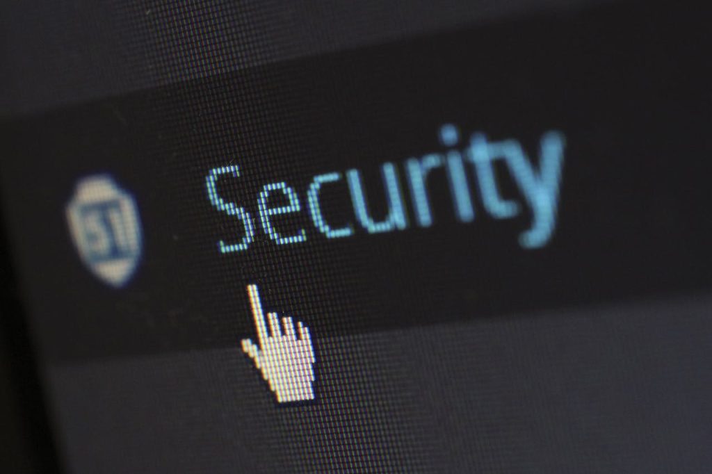 security-logo-60504 Close-up view of a mouse cursor over digital security text on display.